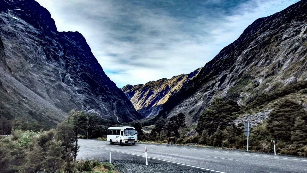 Tracknet bus amongst mountains on Milford Sound Road