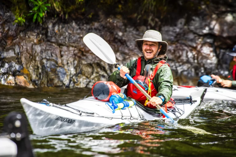 Happy kayaker in Doubtful Sound
